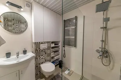 a bathroom with a shower and a toilet and a sink at City center de Lux apartment in Bar