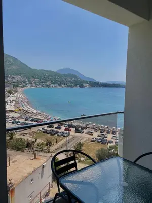 a balcony with a view of a beach and the ocean at Hotel Kaligrosh in Sutomore