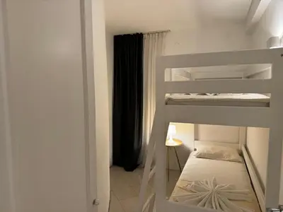 a bedroom with two bunk beds in a room at Front Row Sunset in Rafailovici