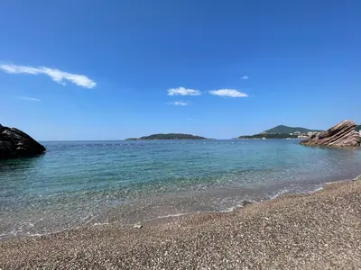 a beach with a rocky shore and the ocean at Front Row Sunset in Rafailovici