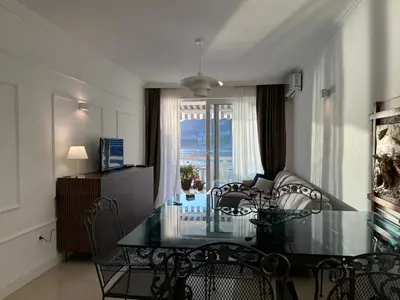 a dining room with a glass table and chairs at Front Row Sunset in Rafailovici