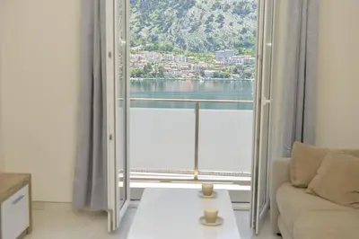 a living room with a large window with a view at Apartments Seaview Estate Radovic in Kotor