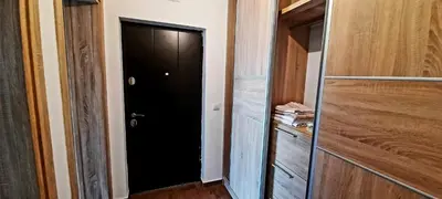 a hallway with a black door and a closet at Sara apartman in Bar