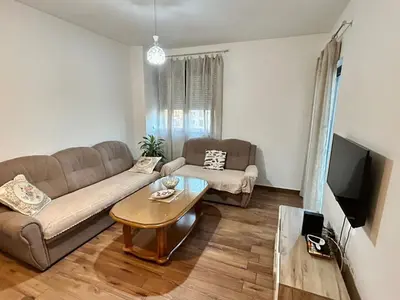 a living room with a couch and a table at Sara apartman in Bar