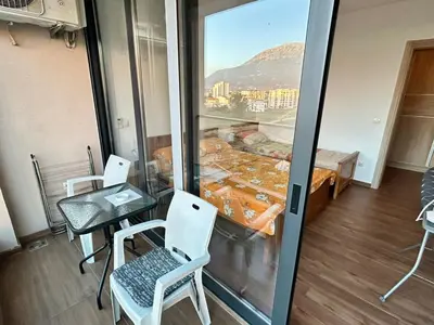a room with a table and chairs and a window at Sara apartman in Bar