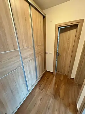 an empty room with wood paneling and a door at Sara apartman in Bar