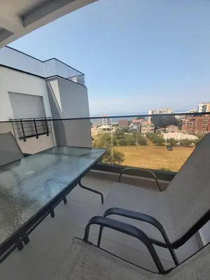 a balcony with a table and chairs and a view at Apartmani Aida in Dobra Voda