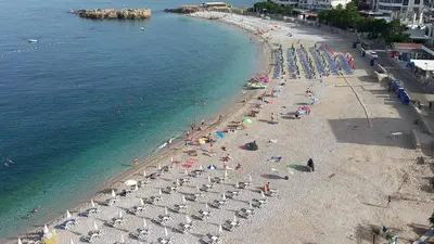 an overhead view of a beach with people and umbrellas at Apartmani Aida in Dobra Voda