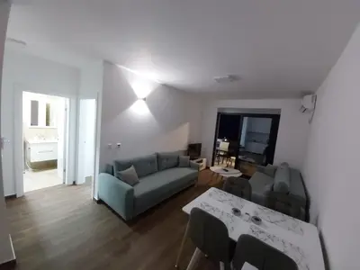 a living room with a couch and a table at Apartmani Aida in Dobra Voda