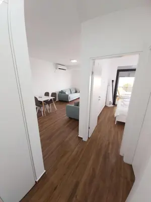 a living room with a couch and a table at Apartmani Aida in Dobra Voda