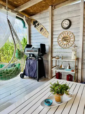 a room with a table and a clock on a wall at Sojenica Ivona in Ulcinj