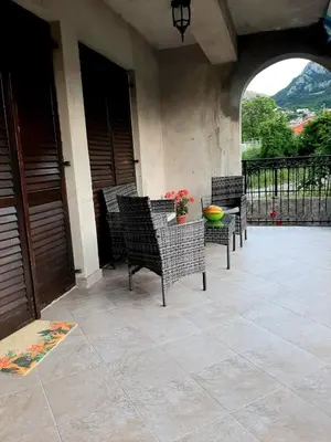 a patio with chairs and a table on a balcony at Andrej Apartments in Kotor