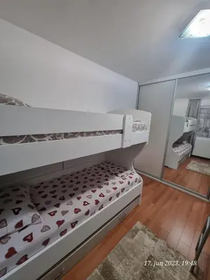a white bunk bed in a room with a mirror at BOK HOLIDAY HOME Petrovac in Petrovac na Moru