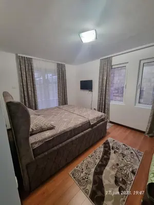 a bedroom with a bed and a chair in it at BOK HOLIDAY HOME Petrovac in Petrovac na Moru