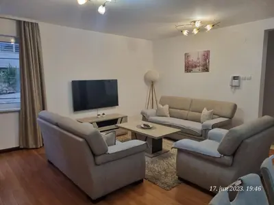 a living room with couches and a flat screen tv at BOK HOLIDAY HOME Petrovac in Petrovac na Moru