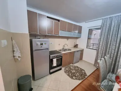 a small kitchen with a refrigerator and a sink at BOK HOLIDAY HOME Petrovac in Petrovac na Moru