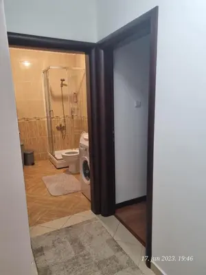 a bathroom with a toilet and a glass door at BOK HOLIDAY HOME Petrovac in Petrovac na Moru