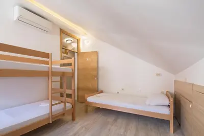 a room with two bunk beds and a staircase at CENTRUM HOSTEL in Kotor