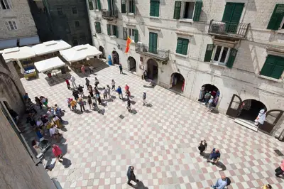 an overhead view of a crowd of people walking around a courtyard at CENTRUM HOSTEL in Kotor
