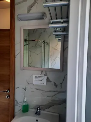 a bathroom with a mirror and a sink at CENTRUM HOSTEL in Kotor