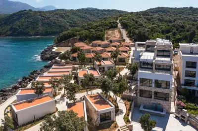 an aerial view of an apartment complex next to the water at Dulamerovic Resort in Bar