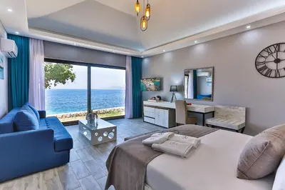 a bedroom with a large bed and a blue couch at Dulamerovic Resort in Bar