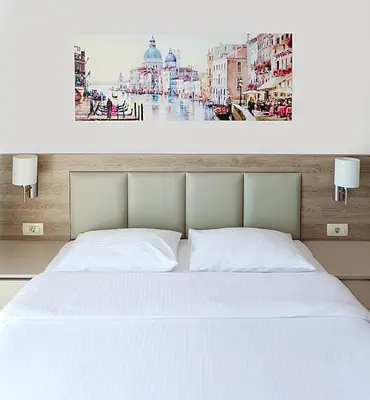 a bedroom with a white bed and a picture of a city at Tophill Altezza Premium - best view and pool in Budva