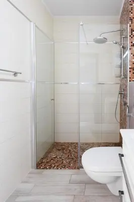 a bathroom with a glass shower stall and a toilet at Tophill Altezza Premium - best view and pool in Budva