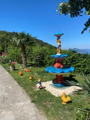 a statue of a dog sitting on top of a water fountain at Apartment Lorena in Kotor