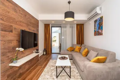 a living room with a couch and a tv at Accordion Apartment in Bar