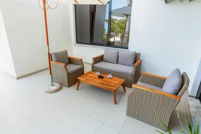 a patio with two chairs and a coffee table at Accordion Apartment in Bar