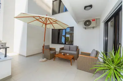 a living room with a couch and an umbrella at Accordion Apartment in Bar