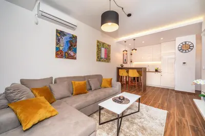 a living room with a couch and a table at Accordion Apartment in Bar