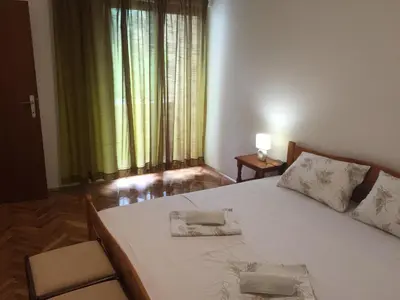 a bedroom with a large white bed with two pillows on it at Apartman-Fenix in Bar, Susanj