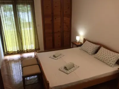 a bedroom with a bed with two pillows on it at Apartman-Fenix in Bar, Susanj
