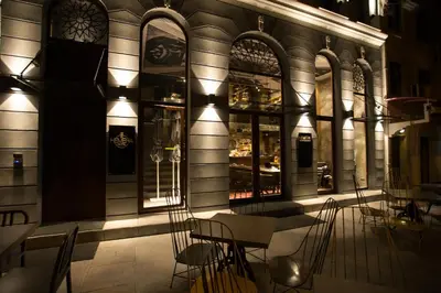 a table and chairs in front of a building at Hotel Hemera in Podgorica