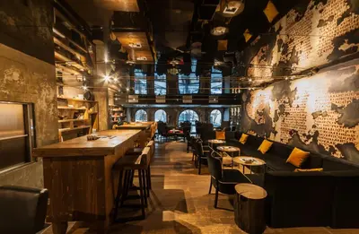 a bar with chairs and tables in a restaurant at Hotel Hemera in Podgorica
