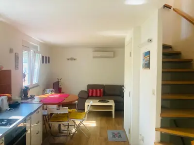 a kitchen and living room with a table and a couch at Podgorica-Downtown in Podgorica
