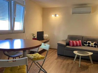 a living room with a table and a couch at Podgorica-Downtown in Podgorica