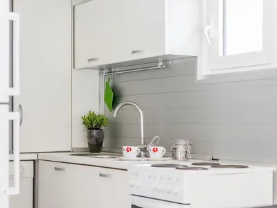a kitchen with white cabinets and a stove top oven at Green Home Apartments in Kotor