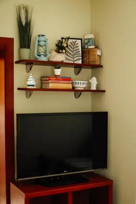 a flat screen tv on a wall with shelves at Villa Casa di Pietra - Budva Old town in Budva