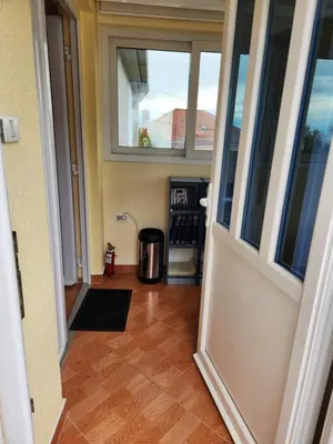 an open door of a house with a trash can at Apartment Dukić in Bar