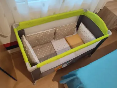 a toy crib with a green and white bed at Apartment Dukić in Bar