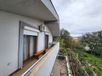 a balcony of a building with a bench on it at Apartment Dukić in Bar