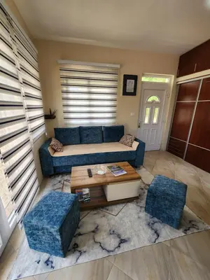 a living room with a blue couch and a table at Apartment Dukić in Bar