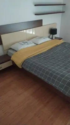 a large bed in a bedroom with a wooden floor at Elena in Bar