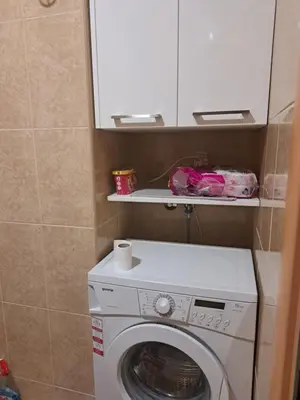 a washing machine in a bathroom with a cabinet at Elena in Bar