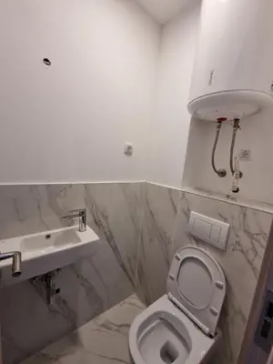 a bathroom with a toilet and a sink at Prestige Central apartments - Rafailovici in Budva