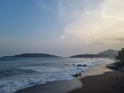 a group of people walking on the beach at Prestige Central apartments - Rafailovici in Budva