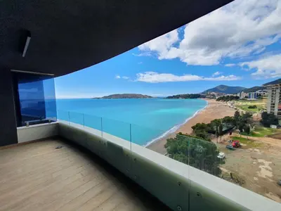 a balcony with a view of a beach and the ocean at Prestige Central apartments - Rafailovici in Budva